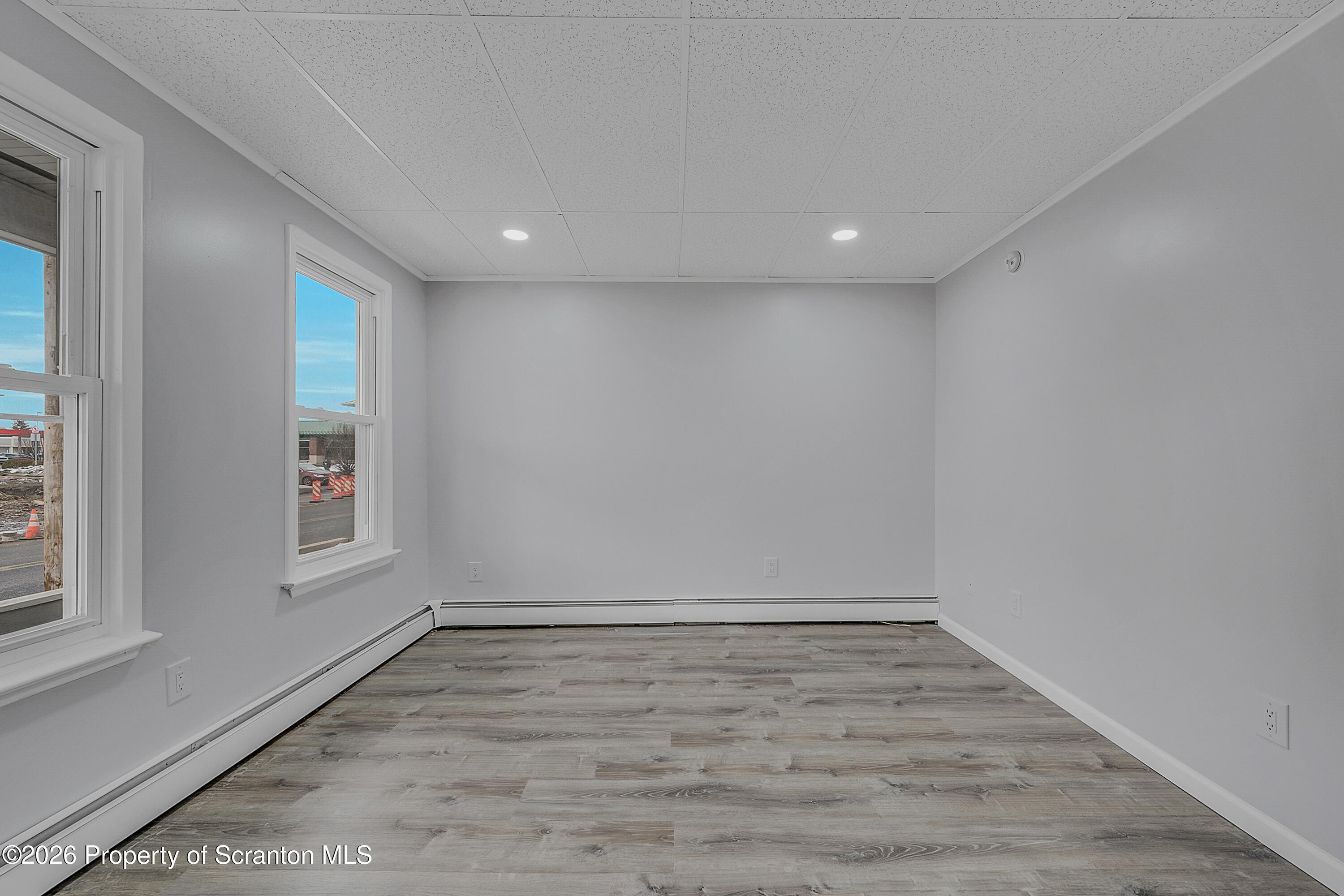 8 Green Ridge Street, Unit 1 Scranton, PA 18509 - Photo 5 of 15 an empty room with wooden floor and windows