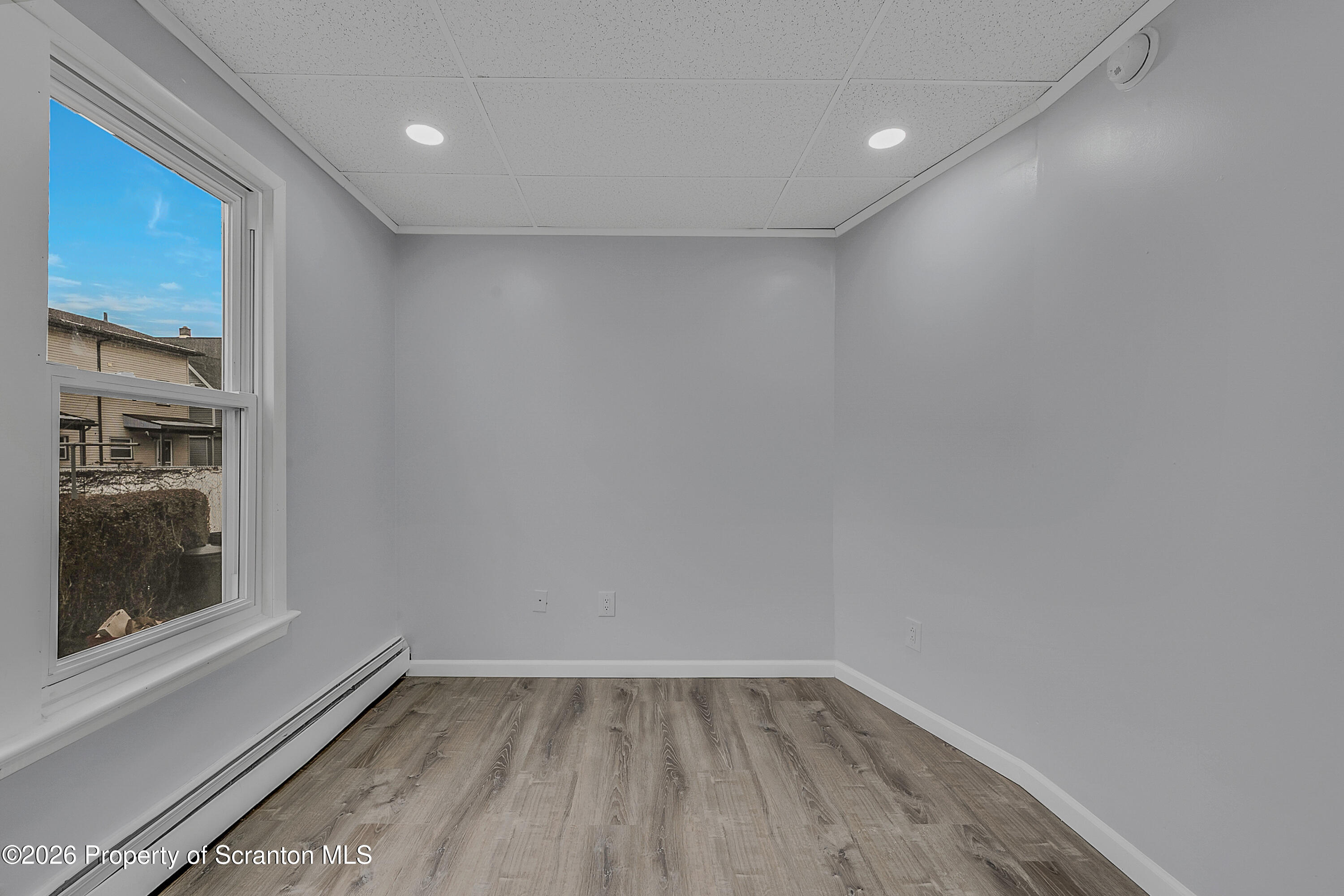 8 Green Ridge Street, Unit 1 Scranton, PA 18509 - Photo 9 of 15 a view of an empty room with a window and wooden floor