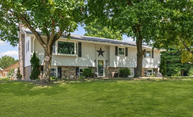 a front view of house with yard and green space
