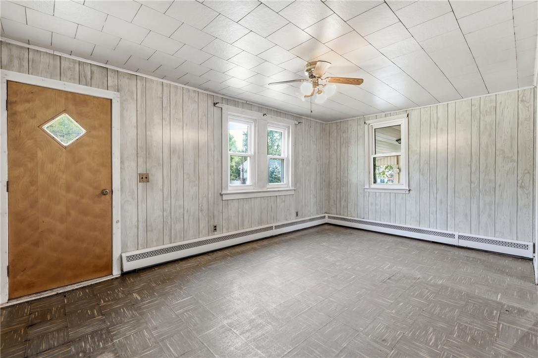 1033 Walt Road Pennsburg, PA 18073 - Photo 8 of 40 Classic wood paneling meets tiled ceilings and vintage parquet-style floors in this versatile room.