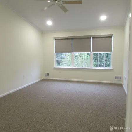 an empty room with a empty space and windows