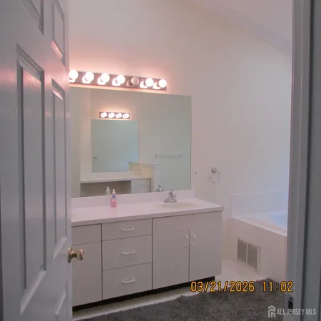 a bathroom with a double vanity sink and a mirror