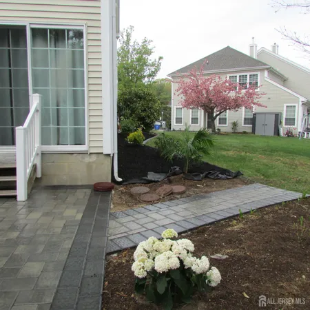 a front view of a house with a yard and a garden