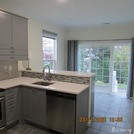 a kitchen with a sink and large window