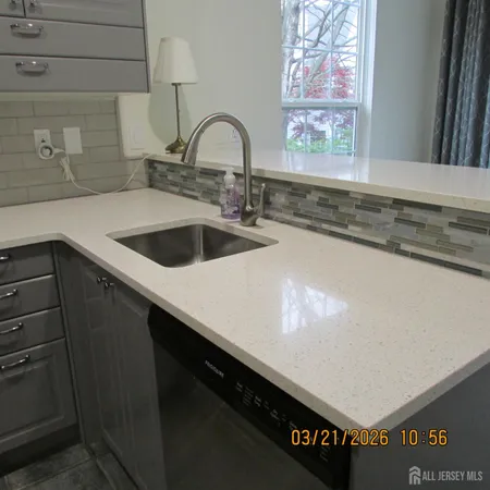 a kitchen with a sink and cabinets