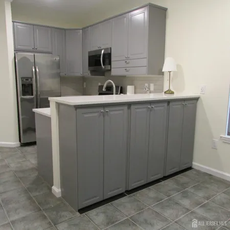 a kitchen with stainless steel appliances a refrigerator and a sink