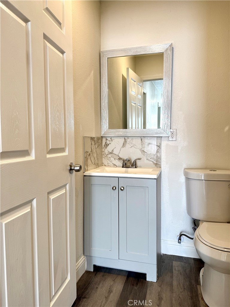 6714 Etiwanda Avenue Reseda, CA 91335 - Photo 3 of 7 a bathroom with a granite countertop toilet sink and mirror