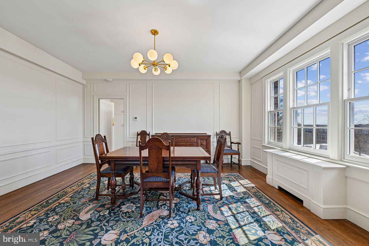 1661 Crescent Place Northwest, Unit 502 Washington, DC 20009 - Photo 24 of 50 a view of a dining room with furniture a rug and wooden floor