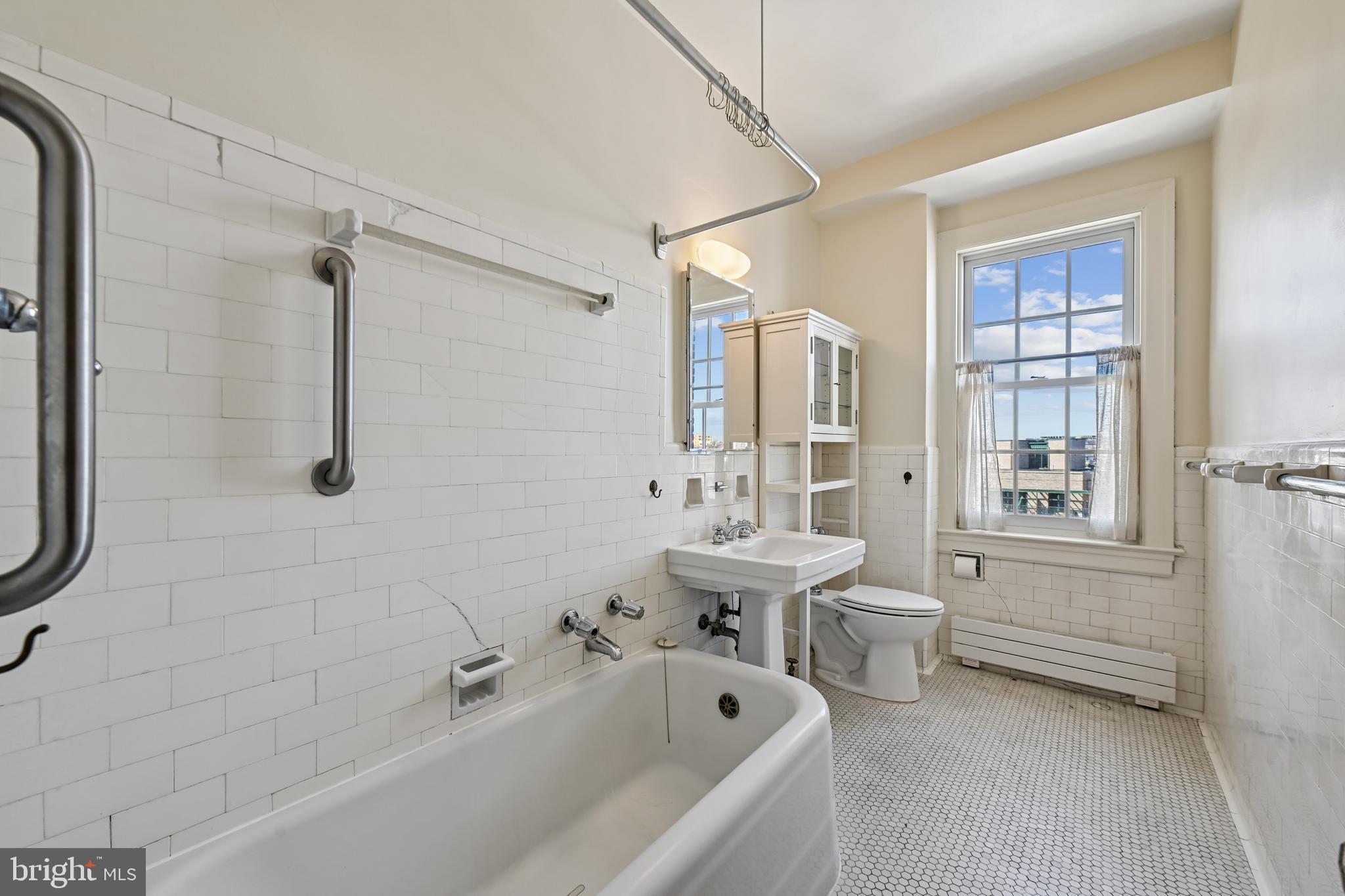 1661 Crescent Place Northwest, Unit 502 Washington, DC 20009 - Photo 31 of 50 a bathroom with a tub sink toilet and a shower