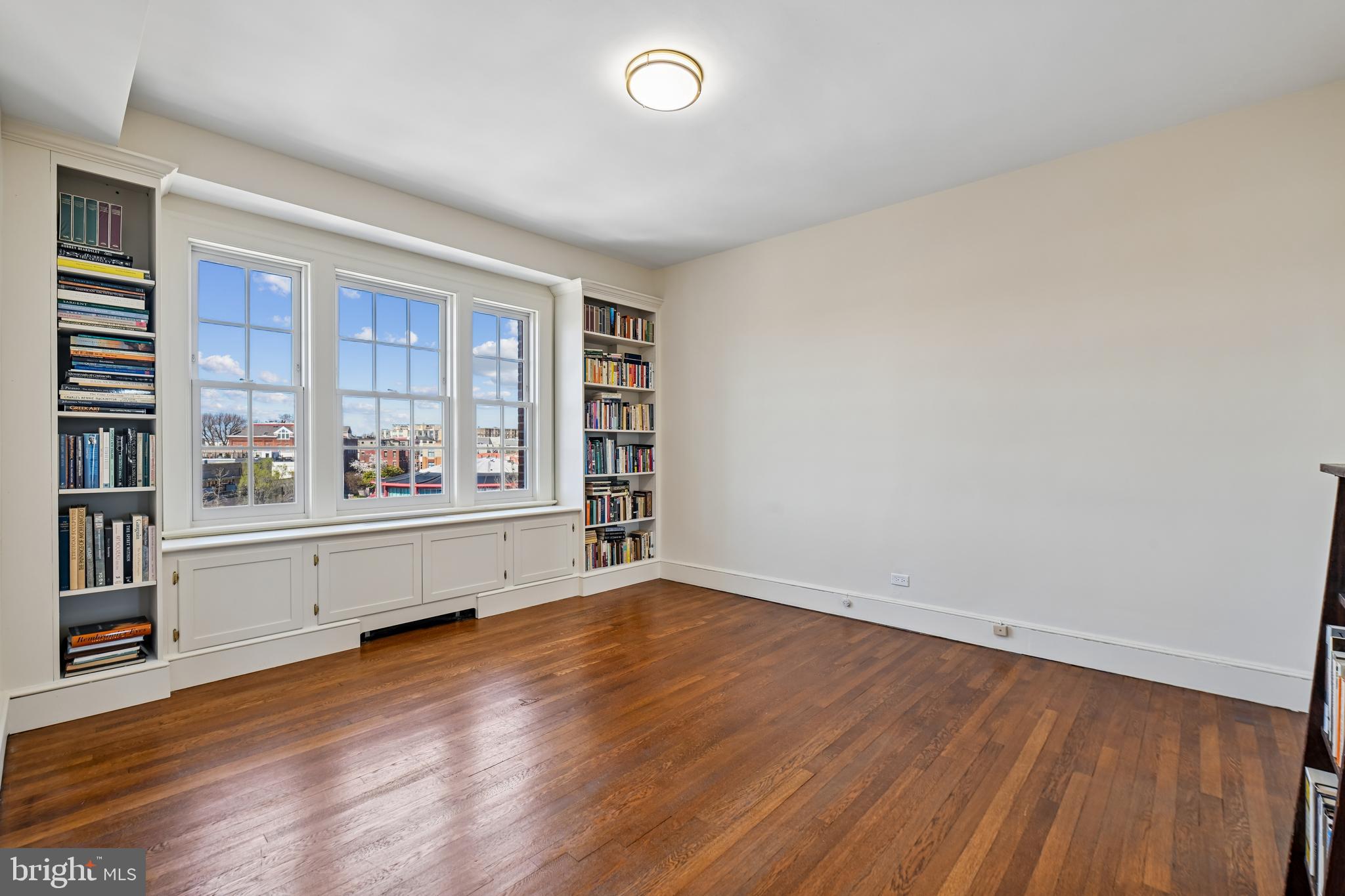 1661 Crescent Place Northwest, Unit 502 Washington, DC 20009 - Photo 32 of 50 an empty room with wooden floor and windows