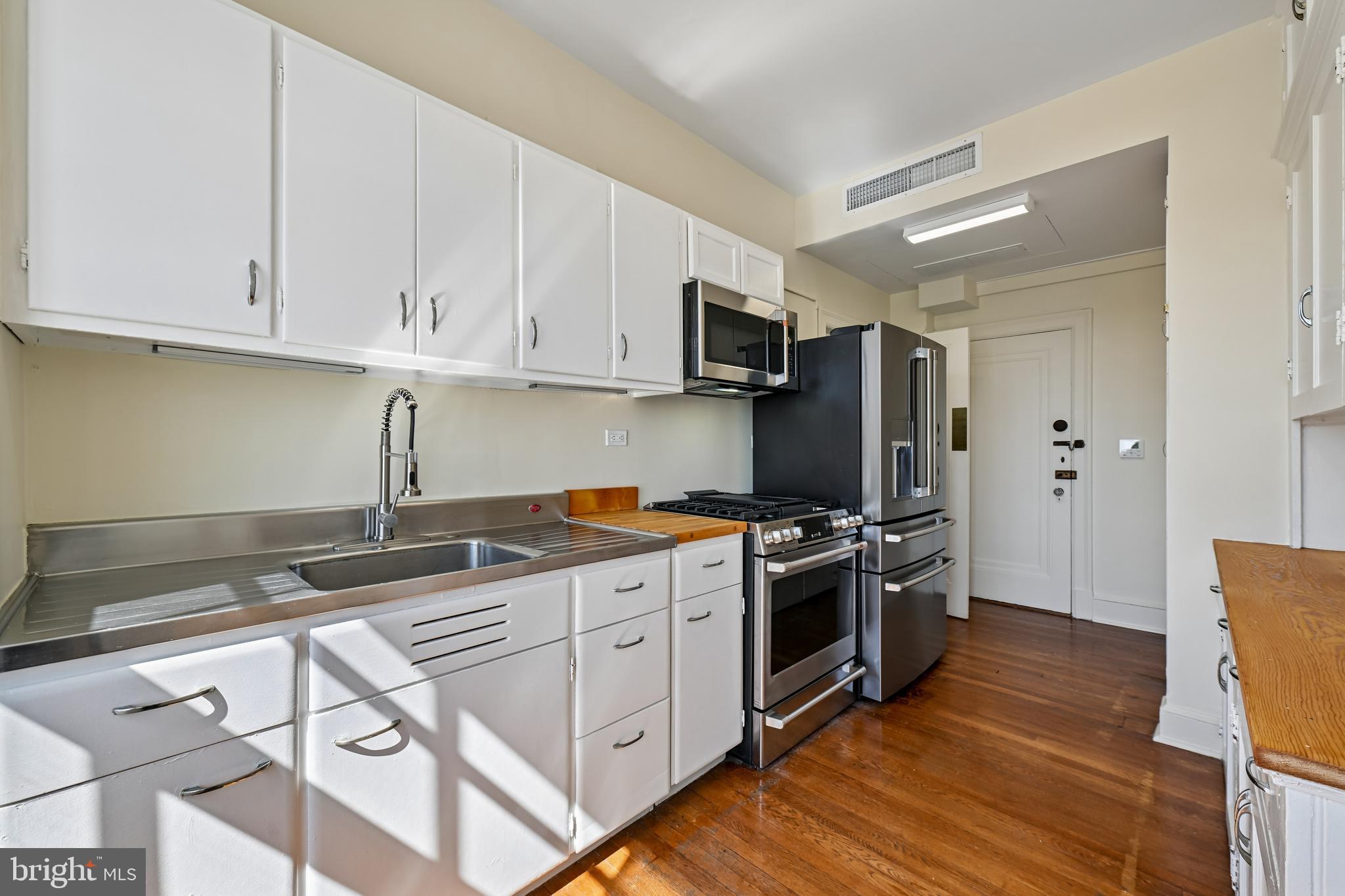 1661 Crescent Place Northwest, Unit 502 Washington, DC 20009 - Photo 7 of 50 a kitchen with stainless steel appliances granite countertop a stove a sink and a refrigerator