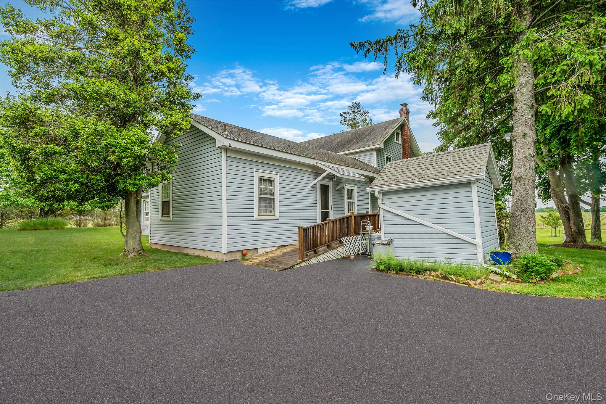 1055 Oregon Road Mattituck, NY 11952 - Photo 27 of 33 Side entry off driveway to handicap ramp leading to a large wood deck and access to the Kitchen.