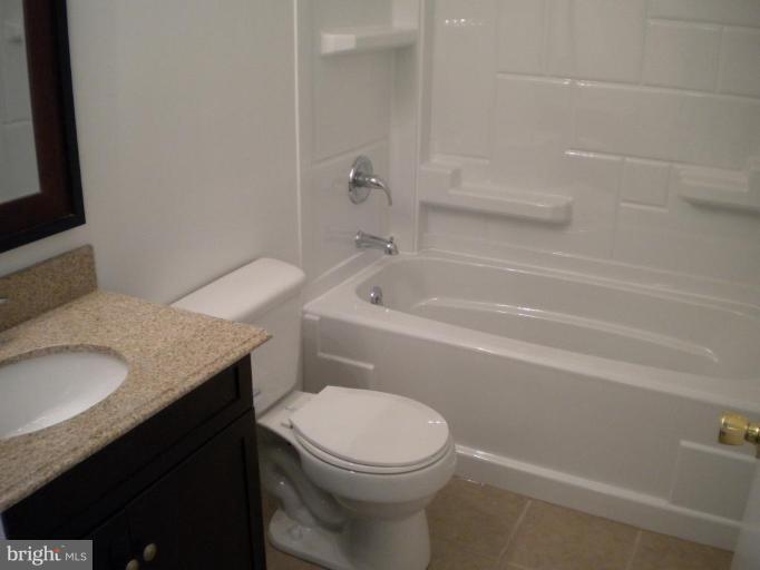 Bath w/ new granite top vanity, tub , tile floor
