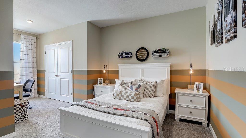 32559 Midsummer Night Lane Wesley Chapel, FL 33543 - Photo 15 of 19 a bedroom with a bed and a lamp on the dresser