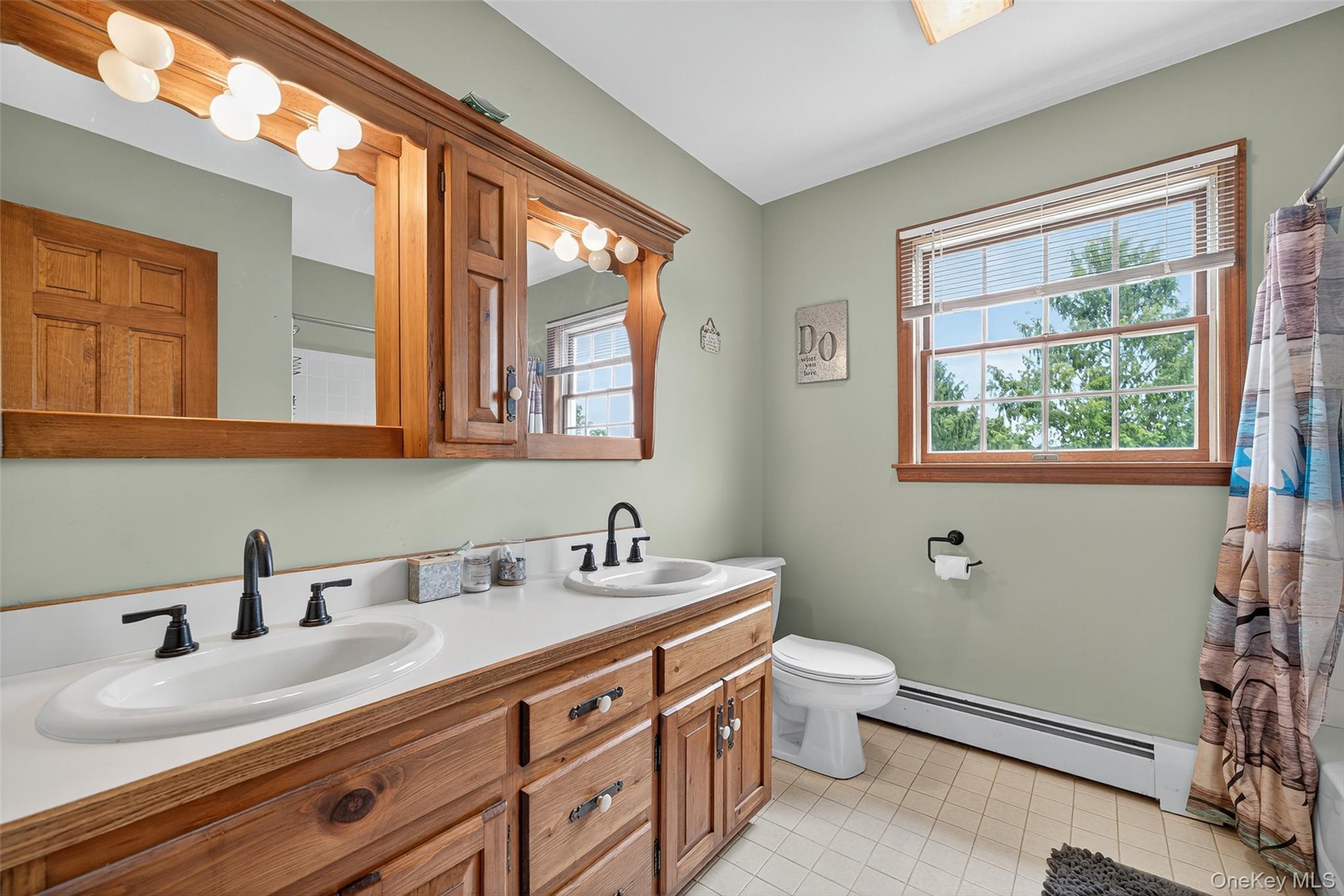 214 Dubois Road Gardiner, NY 12561 - Photo 24 of 38 a bathroom with a double vanity sink toilet and a window