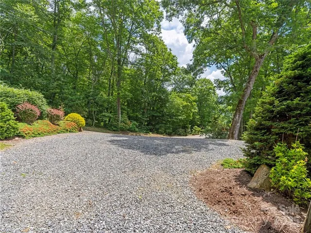 a backyard of a house with barbeque oven table and chairs