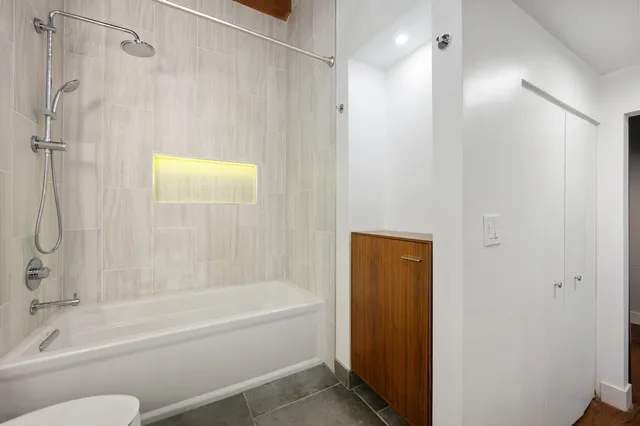 a bathroom with a shower and a bath tub