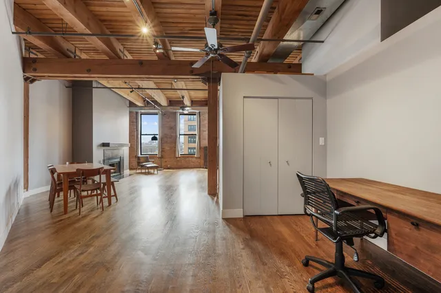 a view of a room with wooden floor and furniture