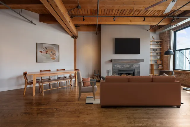 a living room with furniture a flat screen tv and a fireplace