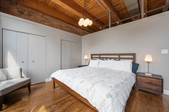 a bedroom with a bed and a chandelier
