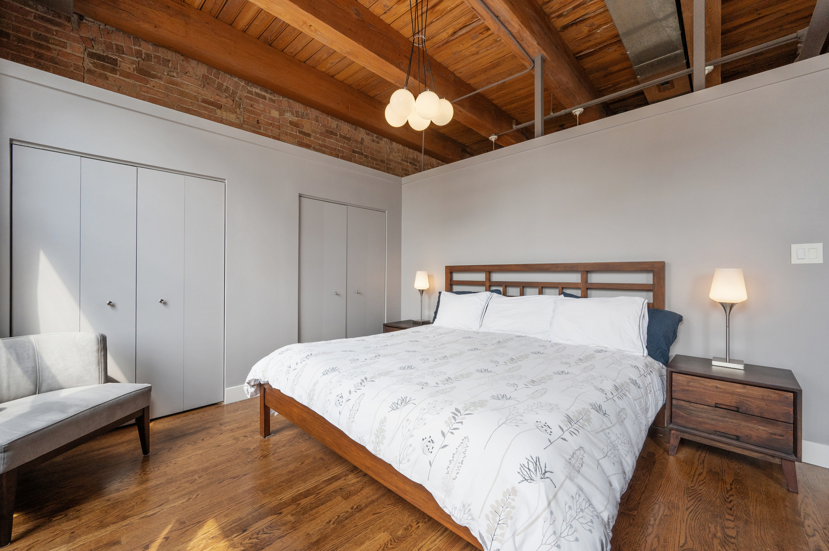 400 South Green Street, Unit 406 Chicago, IL 60607 - Photo 8 of 19 a bedroom with a bed and a chandelier