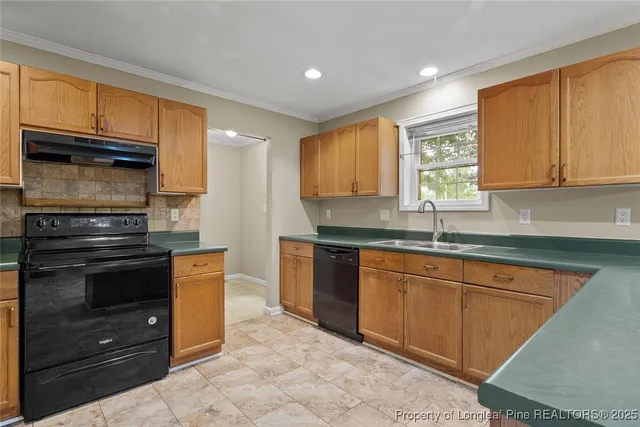 a kitchen with stainless steel appliances granite countertop a stove a refrigerator and a sink