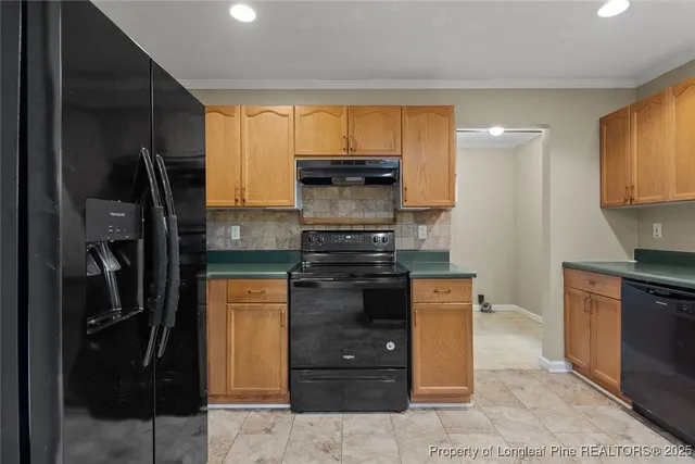 a kitchen with stainless steel appliances granite countertop a refrigerator and a stove top oven