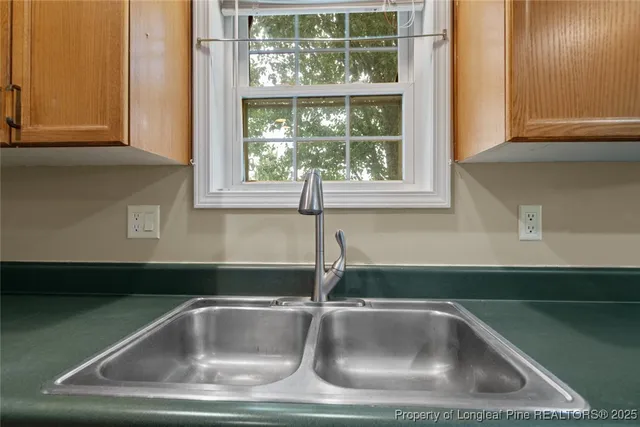 a kitchen with stainless steel appliances granite countertop a sink and a refrigerator