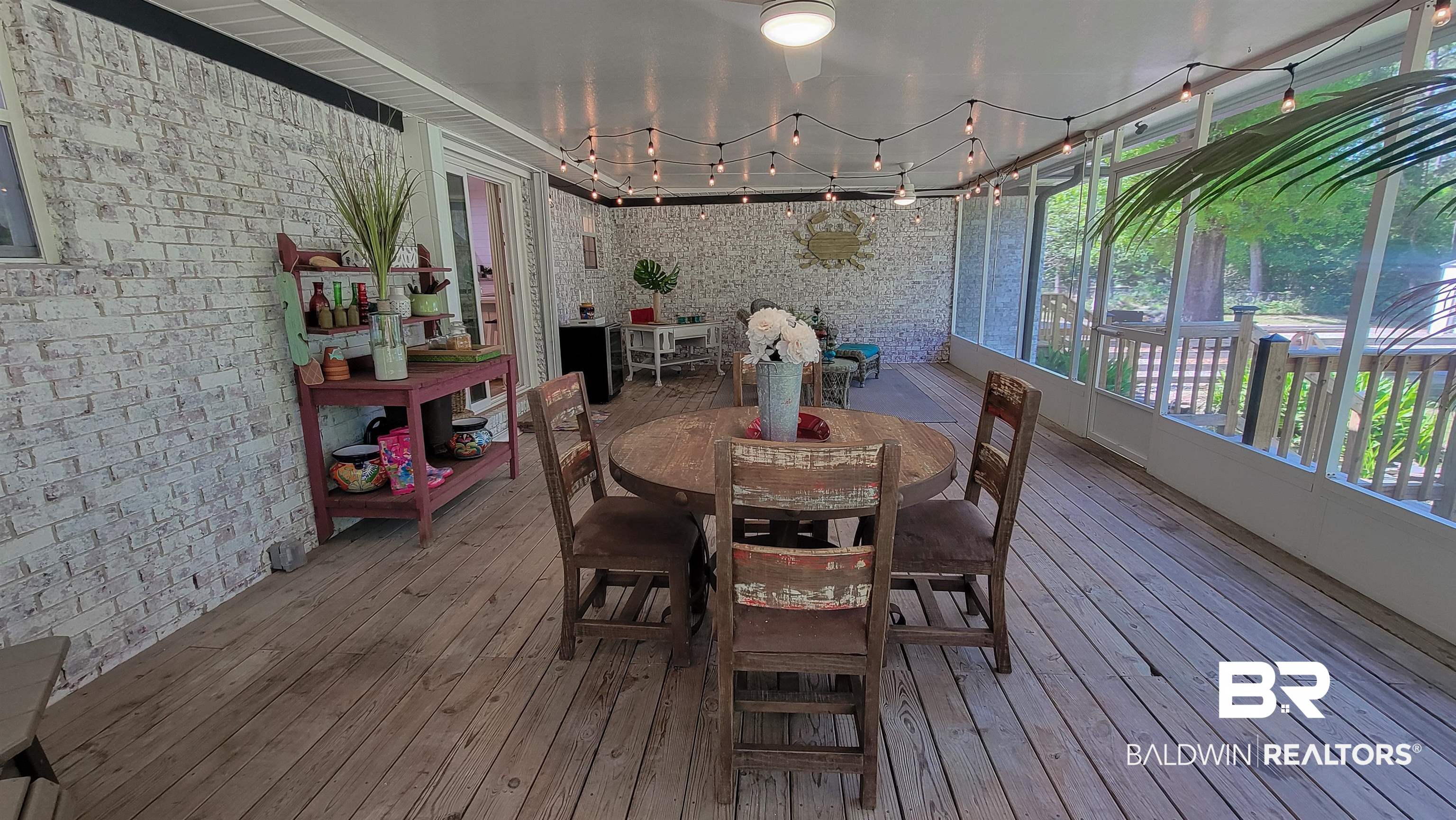 9902 Clarke Ridge Road Foley, AL 36535 - Photo 43 of 61 Sunroom with hardwood / wood-style flooring, brick wall, and a deck
