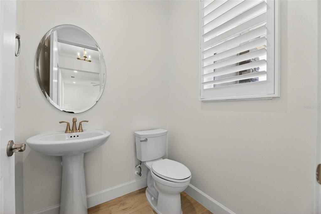 994 Signet Drive Apollo Beach, FL 33572 - Photo 49 of 98 a bathroom with a toilet sink and mirror