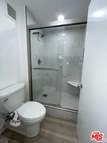 a bathroom with a glass shower door