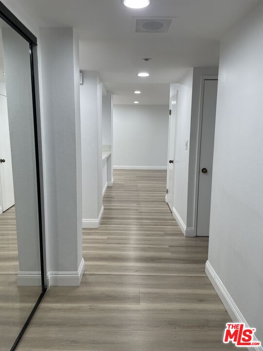 600 West 9th Street, Unit 316 Los Angeles, CA 90015 - Photo 2 of 29 a view of a hallway with wooden floor