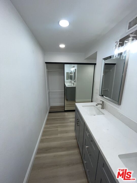 600 West 9th Street, Unit 316 Los Angeles, CA 90015 - Photo 22 of 29 a spacious bathroom with a double vanity sink and mirror