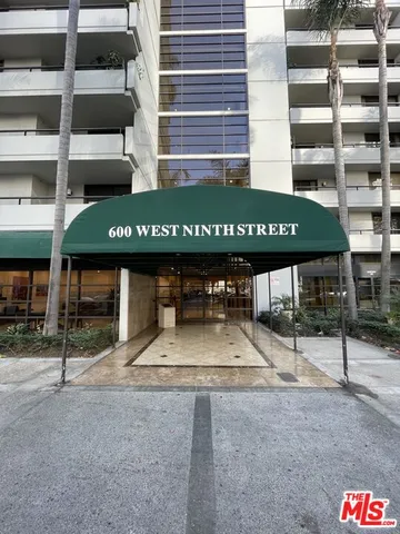 a kitchen with a refrigerator and a counter top space