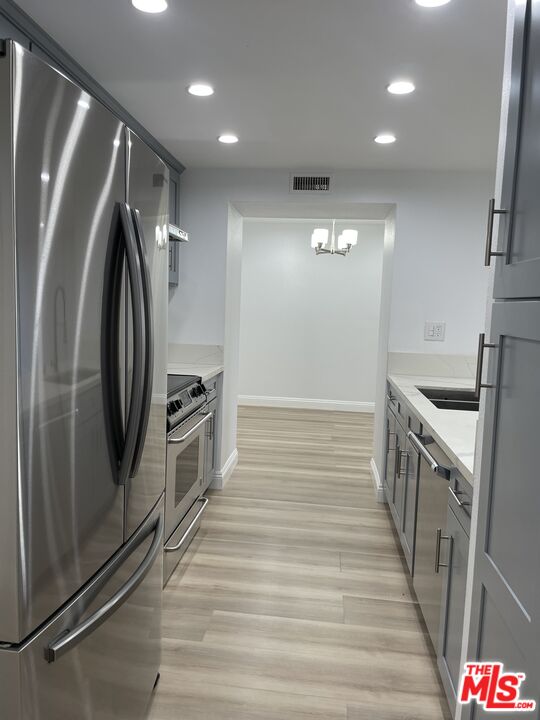 600 West 9th Street, Unit 316 Los Angeles, CA 90015 - Photo 10 of 29 a hallway with washer and dryer