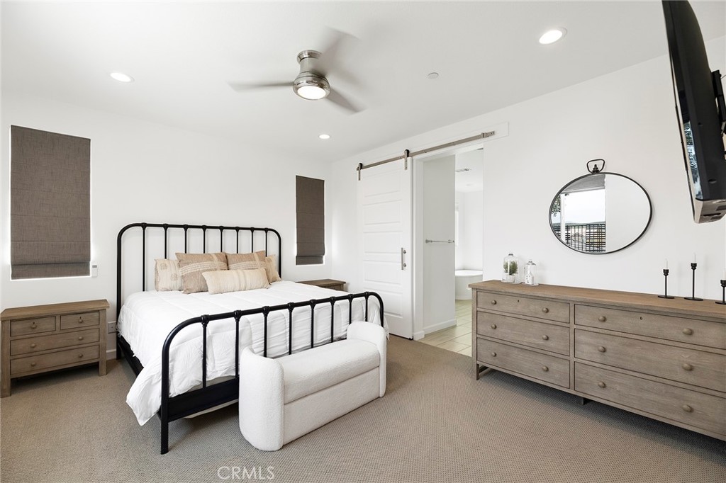32151 Everview Terrace Temecula, CA 92591 - Photo 15 of 39 a bedroom with a bed a chandelier and a mirror on dresser