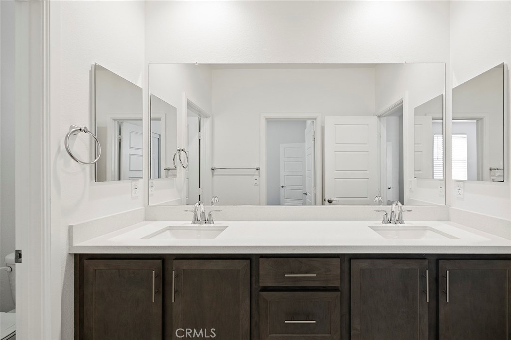 32151 Everview Terrace Temecula, CA 92591 - Photo 22 of 39 a bathroom with double sink and a mirror