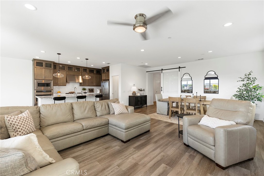 32151 Everview Terrace Temecula, CA 92591 - Photo 8 of 39 a living room with furniture kitchen view and a chandelier