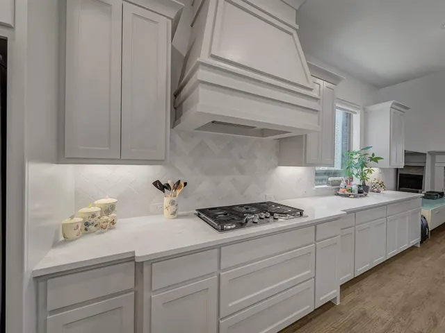 a large kitchen with a table and chairs