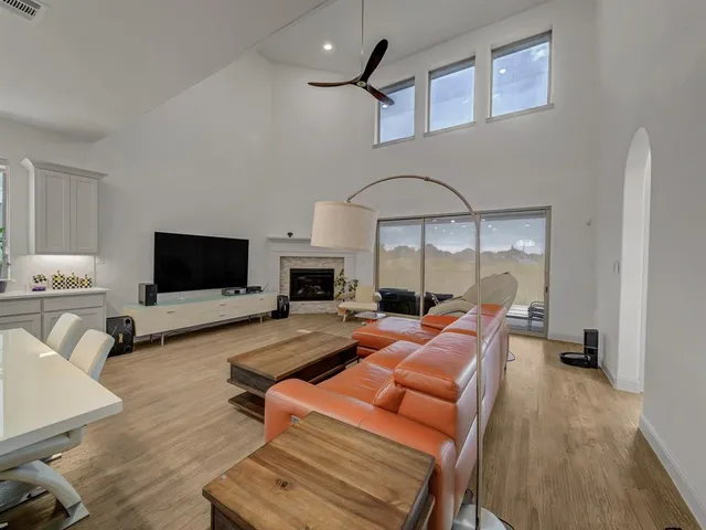 a large white kitchen with a table and chairs