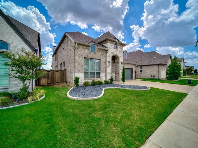 a front view of a house with a yard fire pit and outdoor seating
