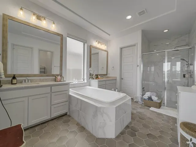 a bedroom with a bed and a flat screen tv on the dresser
