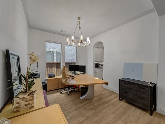 a living room with furniture a chandelier a rug and a chandelier