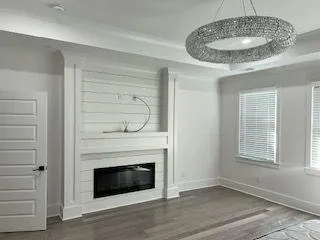 a kitchen with a fireplace and chandelier