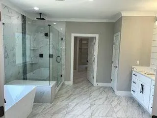 a bathroom with a granite countertop sink a shower and a bathtub