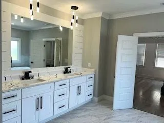 a bathroom with double sink and a mirror