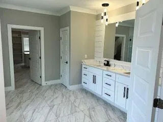 a bathroom with a granite countertop sink mirror and shower