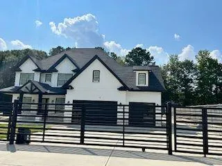 a view of a house with wooden fence