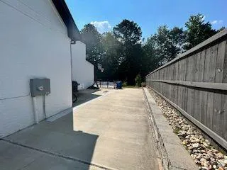 a view of balcony with wooden floor and fence