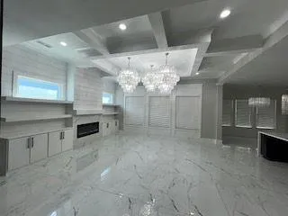 a view of a kitchen with a sink and chandelier
